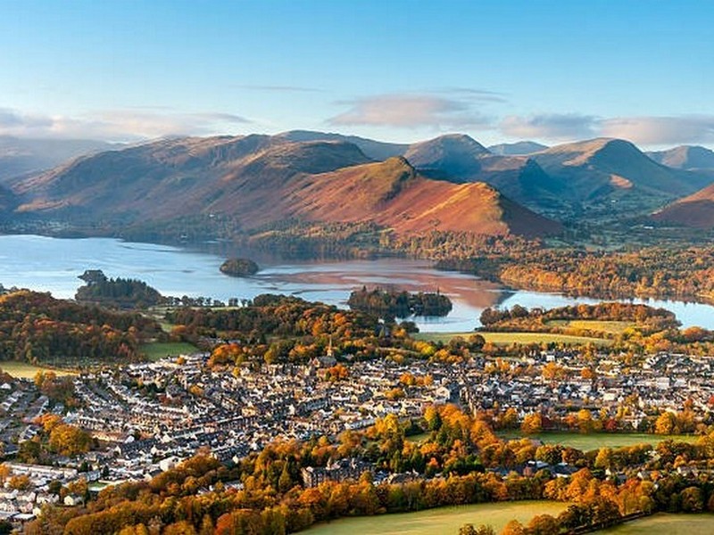 The town of Keswick in the Lake District, with Derwent Water, the Newlands hills, Maiden Moor and Catbells on a sunny day. Keswick marks the end of Day 3 of the Cumbria Way - Great Langdale to Keswick